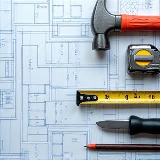 Roofing tools laid out on a blueprint